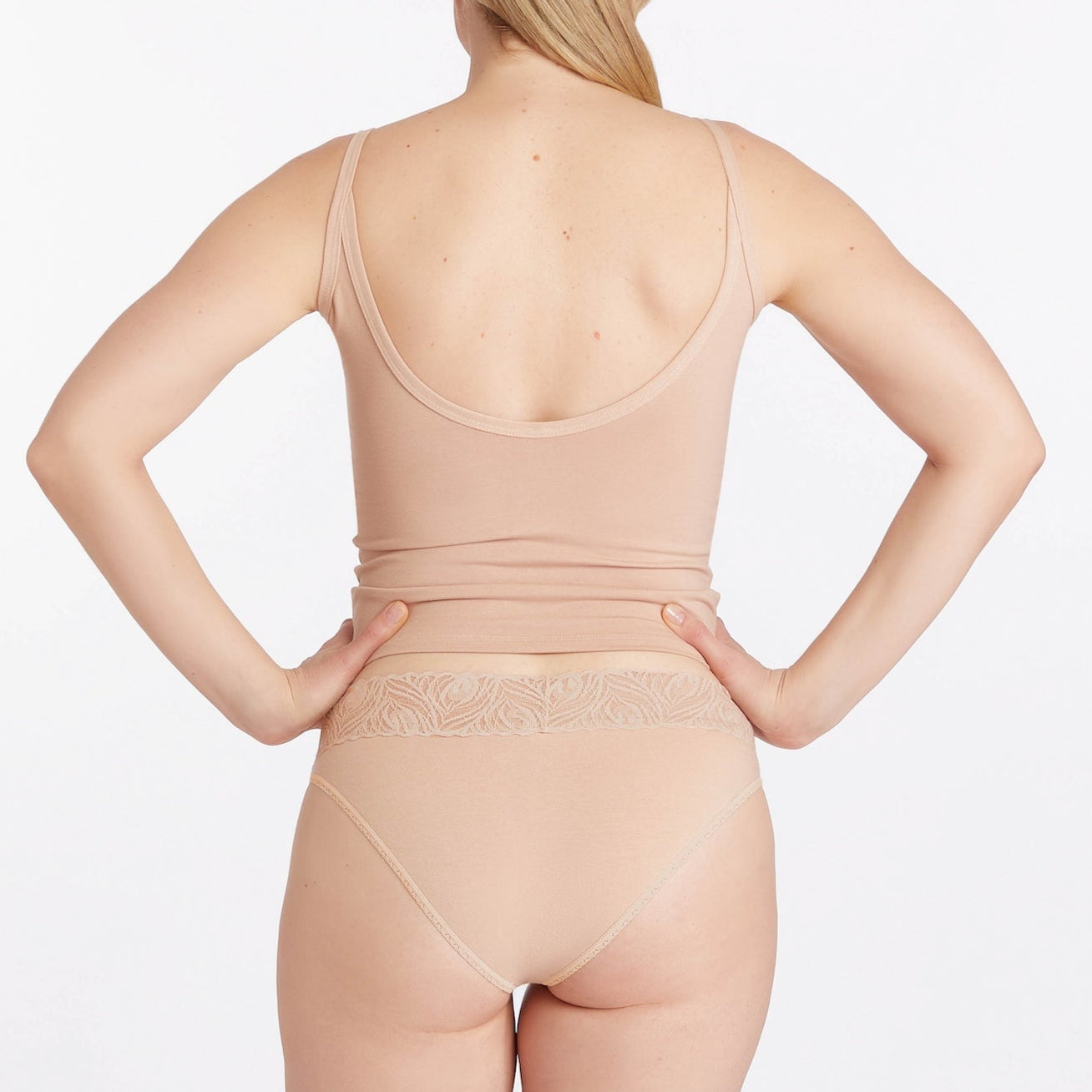 Woman wearing a beige scoop tank and bikini from camofleur