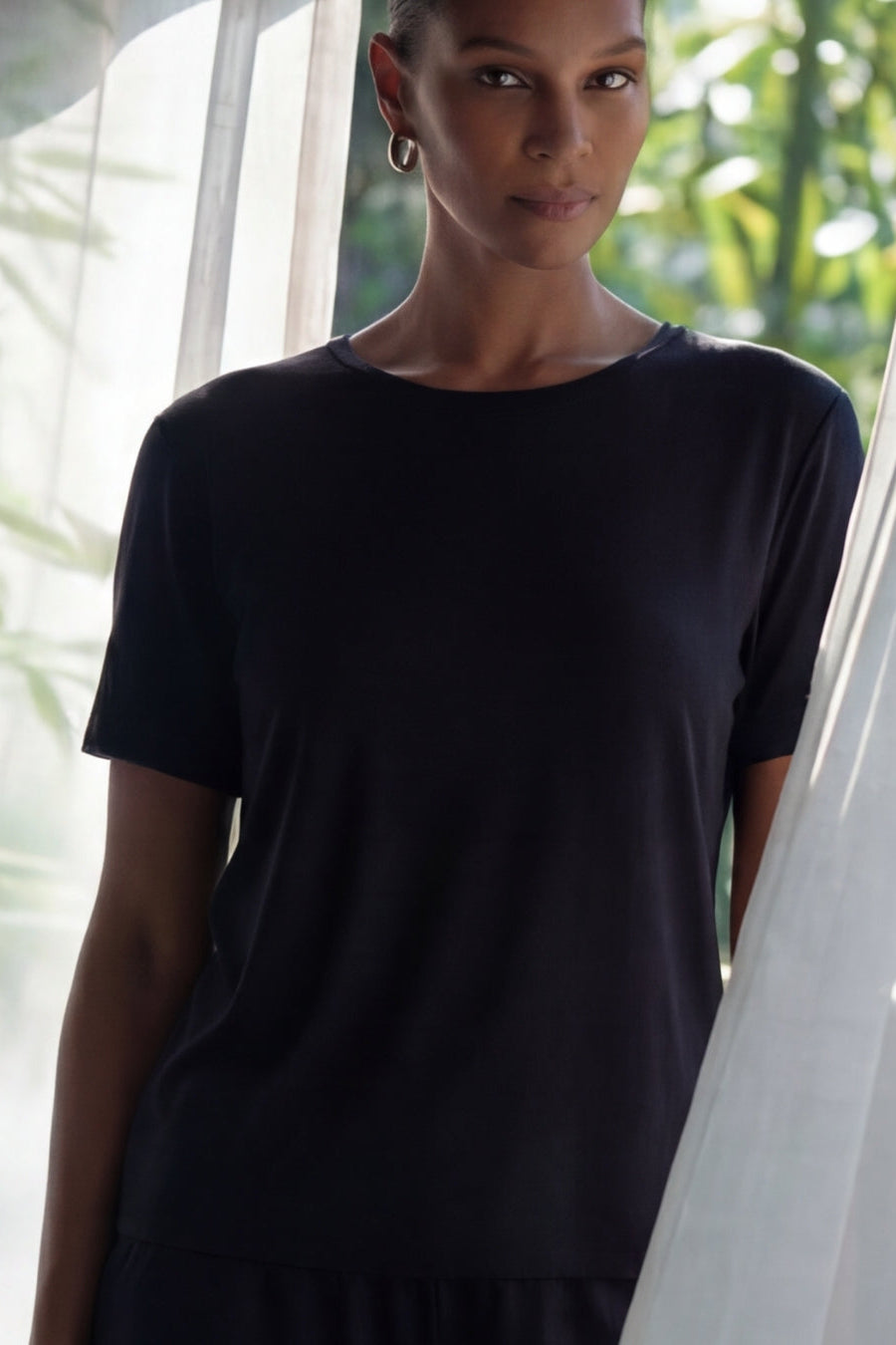 woman standing in a camofleur black bamboo relaxed tee