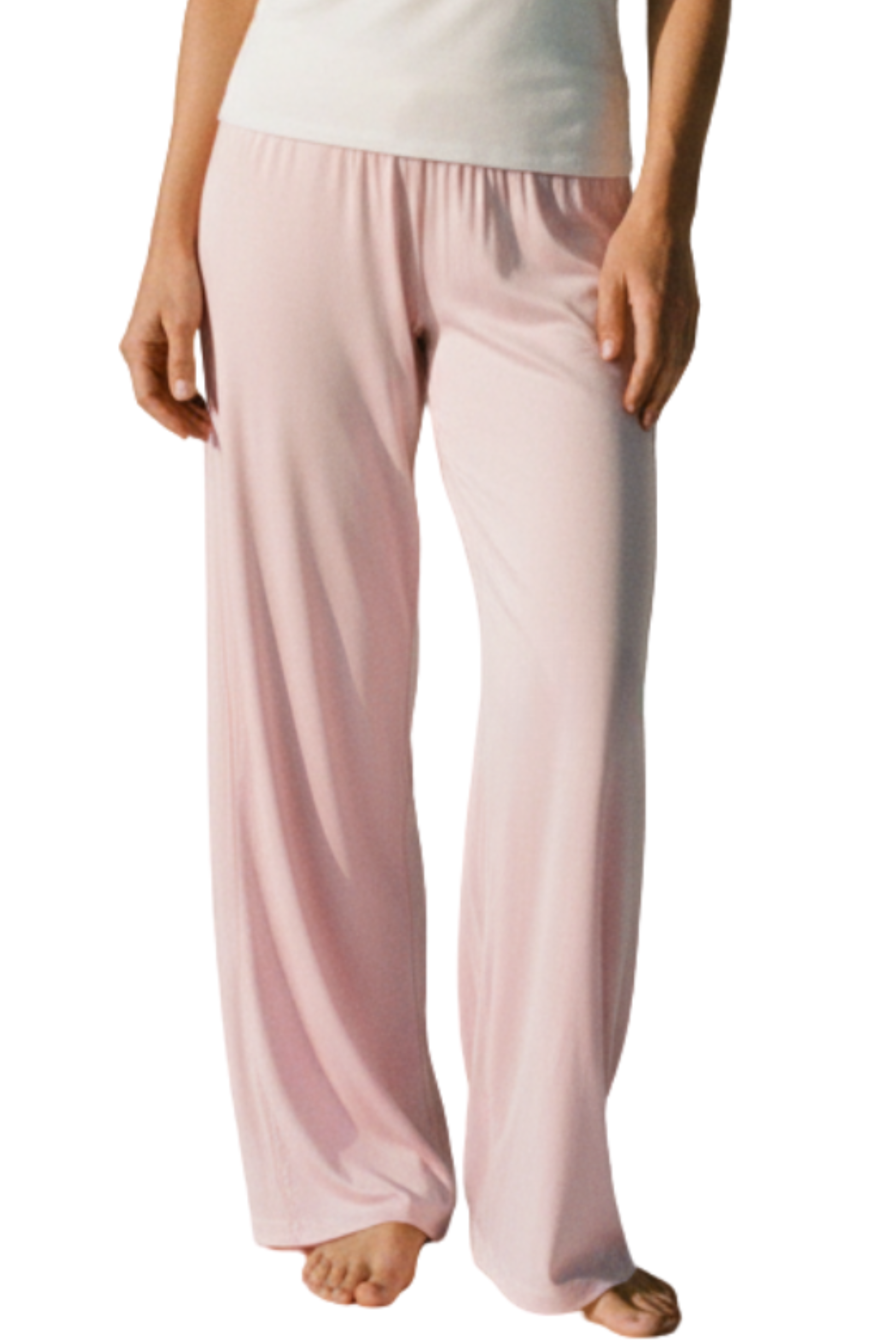 Pink pajama pants from camofleur worn by a woman on a white background