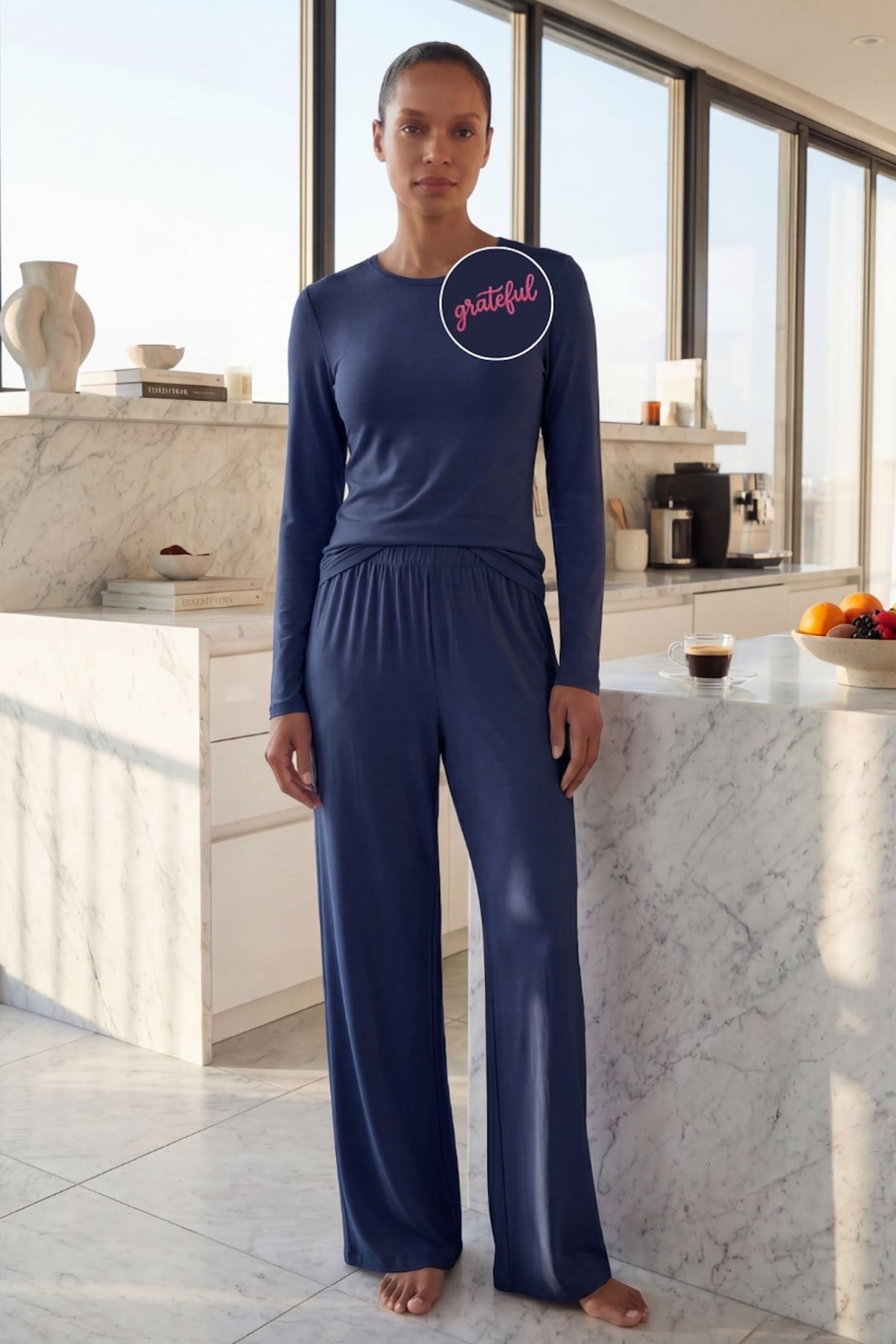 Person wearing a navy blue lounge set from camofleur with 'grateful' embroidery